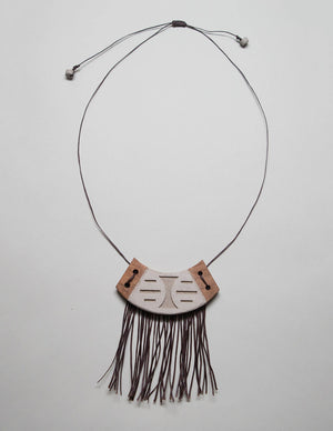 Yomo Studio crescent necklace. Materials include: concrete, walnut wood, and wax string.