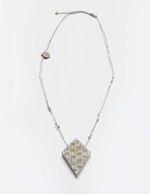 Yomo Studio rhombus lines necklace. Materials include: concrete, metal beads, and wax string.