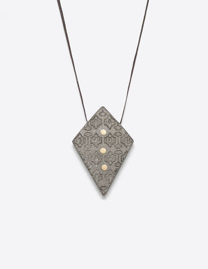 Yomo Studio rhombus dots necklace. Materials include: concrete, brass, metal beads, and wax string.