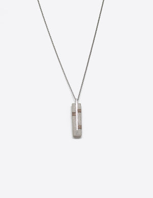 Yomo Studio silver through bricks necklace. Materials include: concrete, 0.992 silver, and walnut wood.