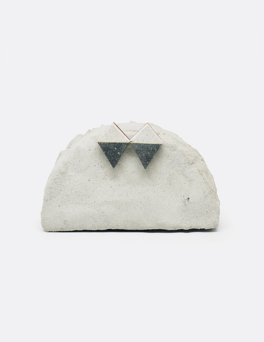 Yomo Studio black & white rhombus earrings. Materials include: concrete, brass, and walnut wood.