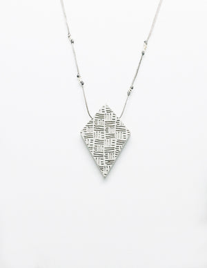 Yomo Studio rhombus lines necklace. Materials include: concrete, metal beads, and wax string.
