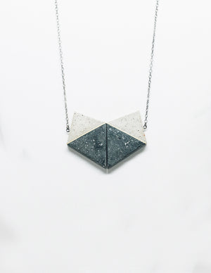 Yomo Studio concrete heart necklace. Materials include: concrete, brass, and silver chain.